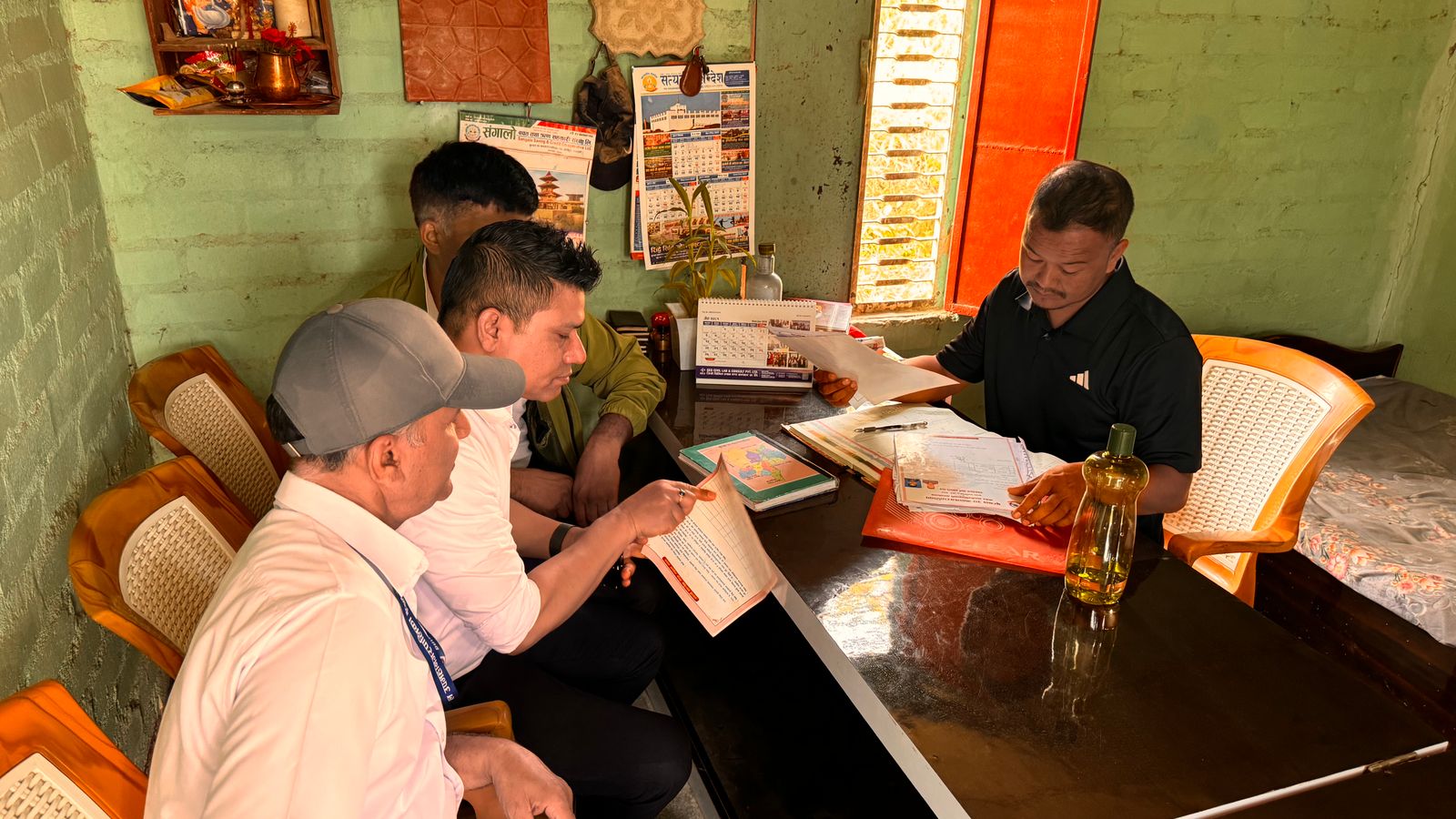 Men working together in a cozy office space with documents and calendars visible.