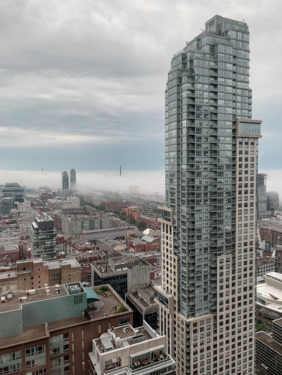 Photo of High-Rise Building Under Cloudy Sky