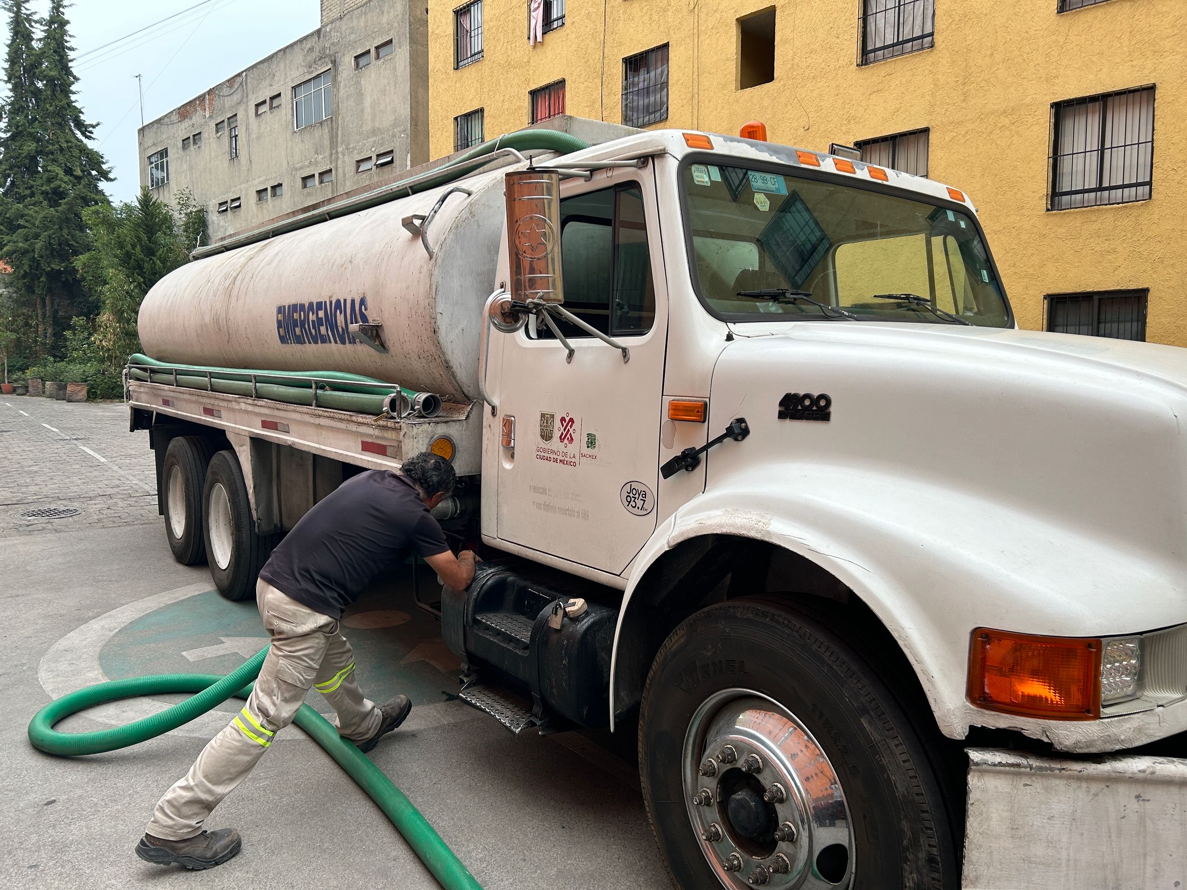 Vacuum tanker truck operating in an urban service area, daylight.