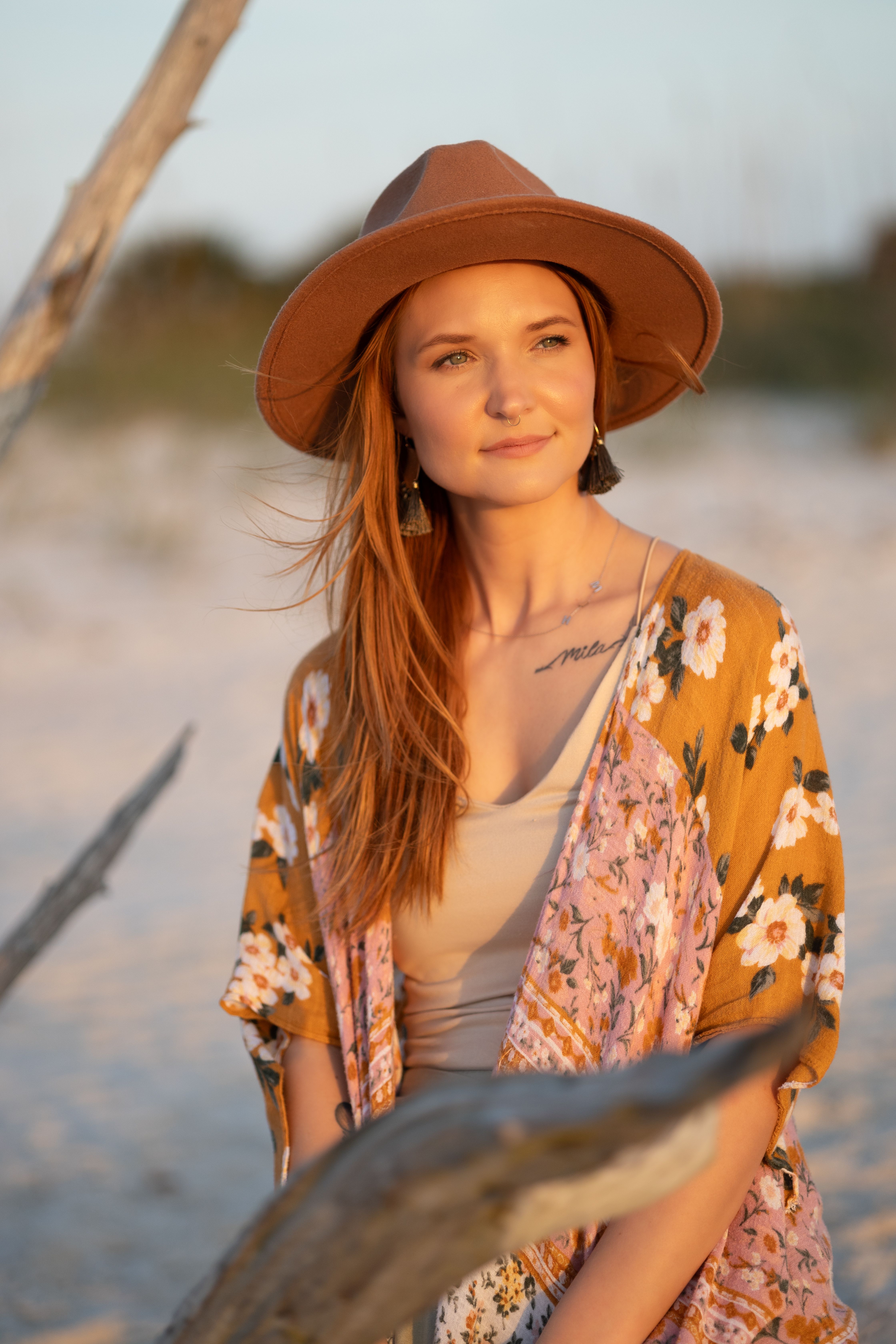 Young woman in a hat enjoying the sunset at New Smyrna Beach, Florida.