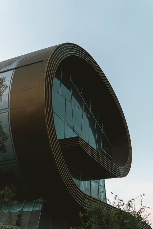 Free Modern structure in Baku with unique round design and glass facade under a clear sky. Stock Photo