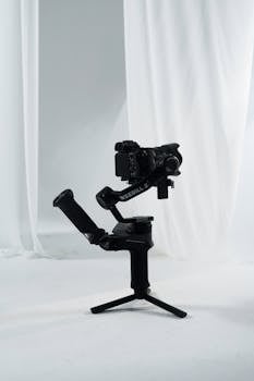 High-quality mirrorless camera mounted on a Weebill 2 gimbal, set in a minimalist photo studio.