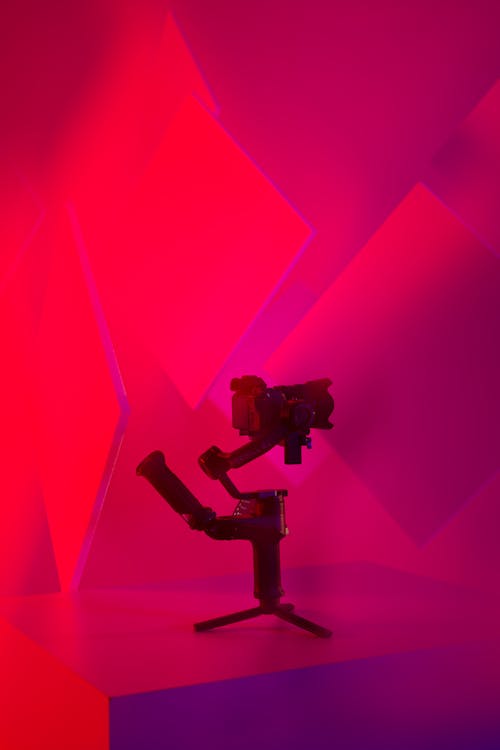 A red and purple light is on a tripod
