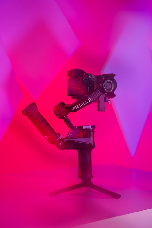 A camera tripod with a purple background