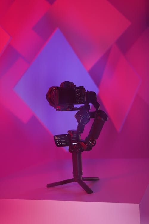 A camera tripod with a purple background