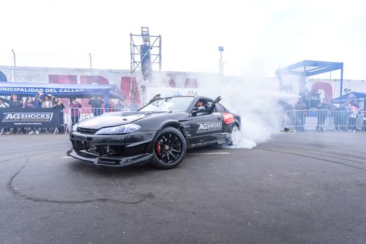 Exciting drifting event featuring a Nissan Silvia S15 with smoking tires and spectators.