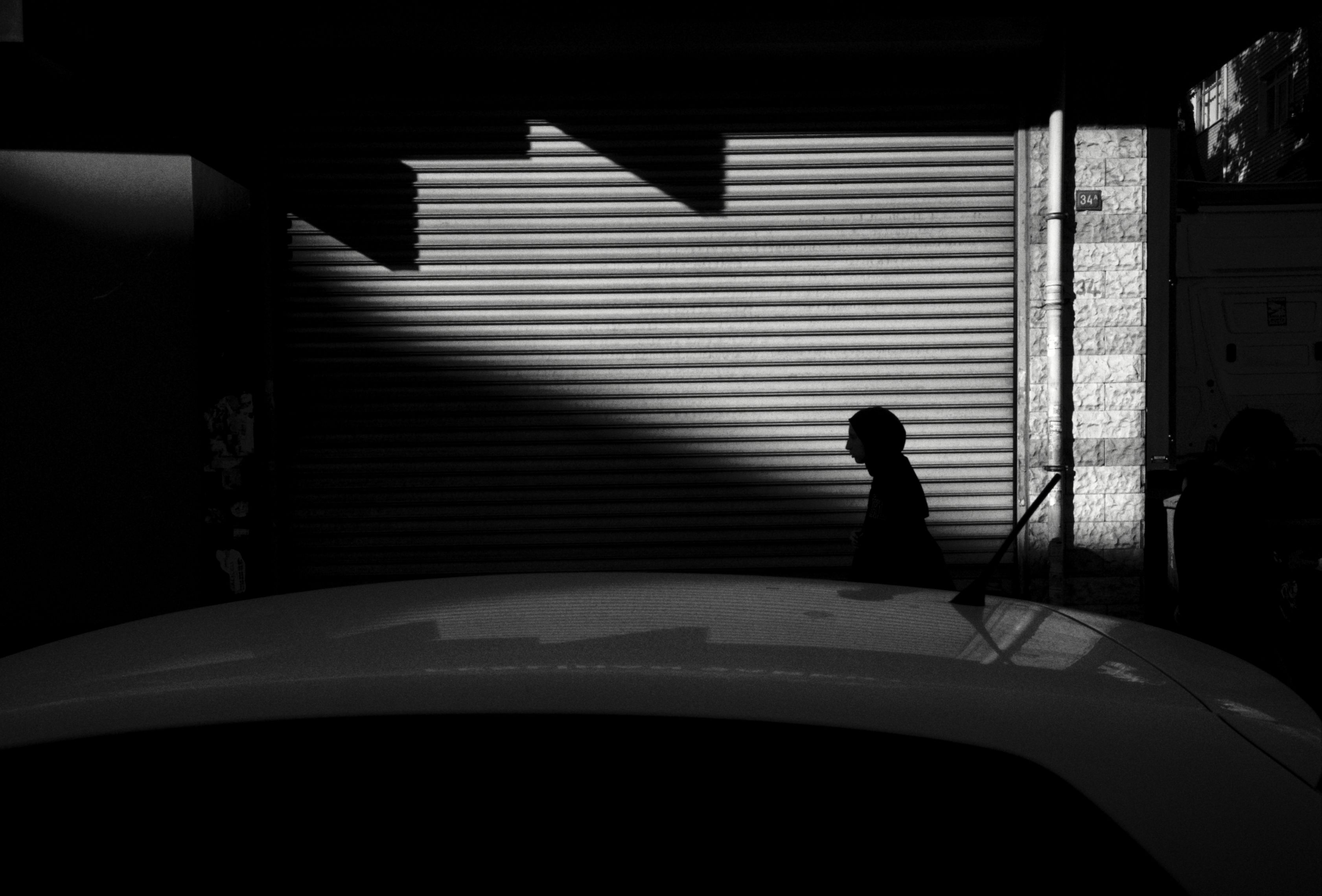 Person Passing from Sunlit into Shadow · Free Stock Photo