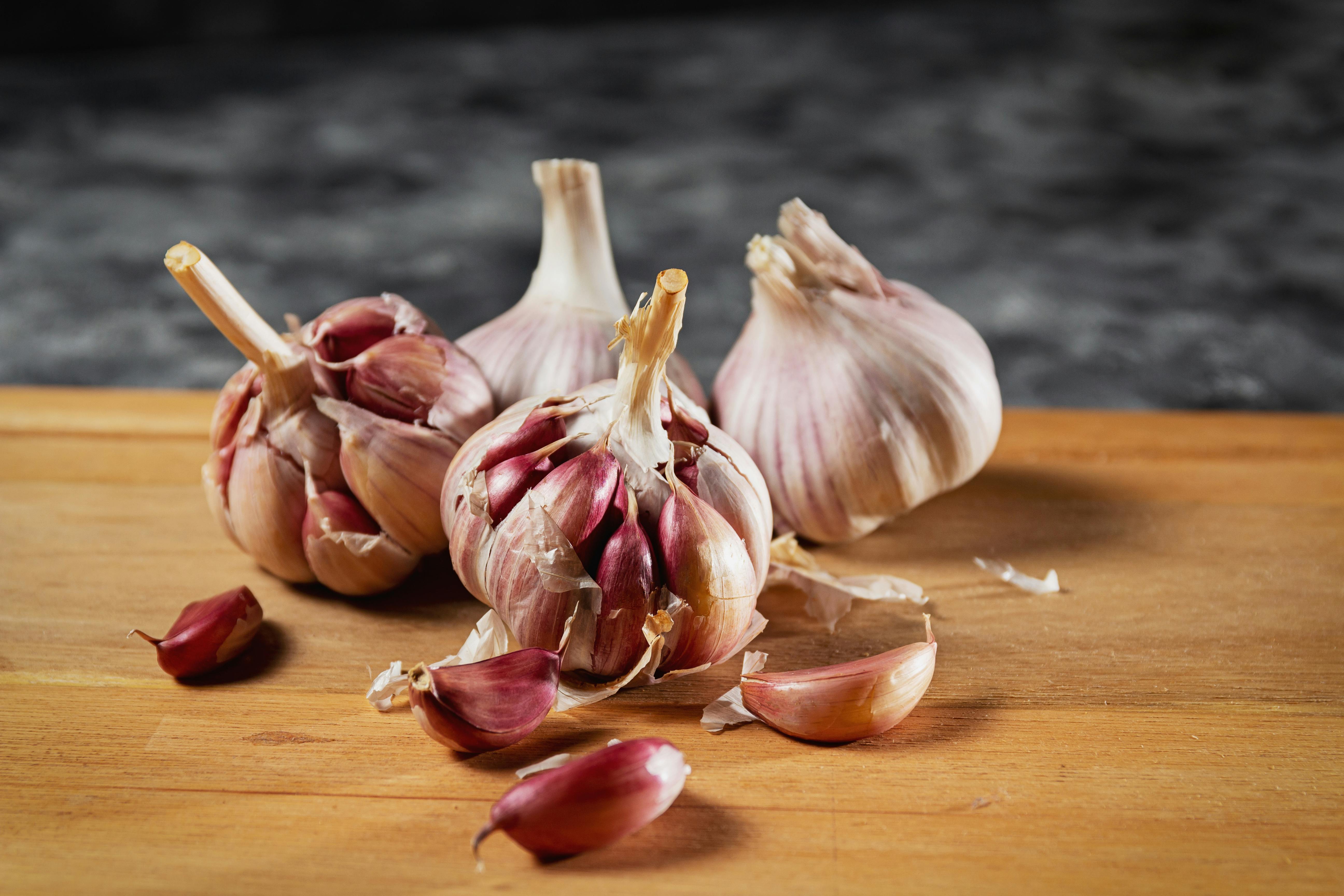 fresh garlic bulbs on cutting board - blood pressure support