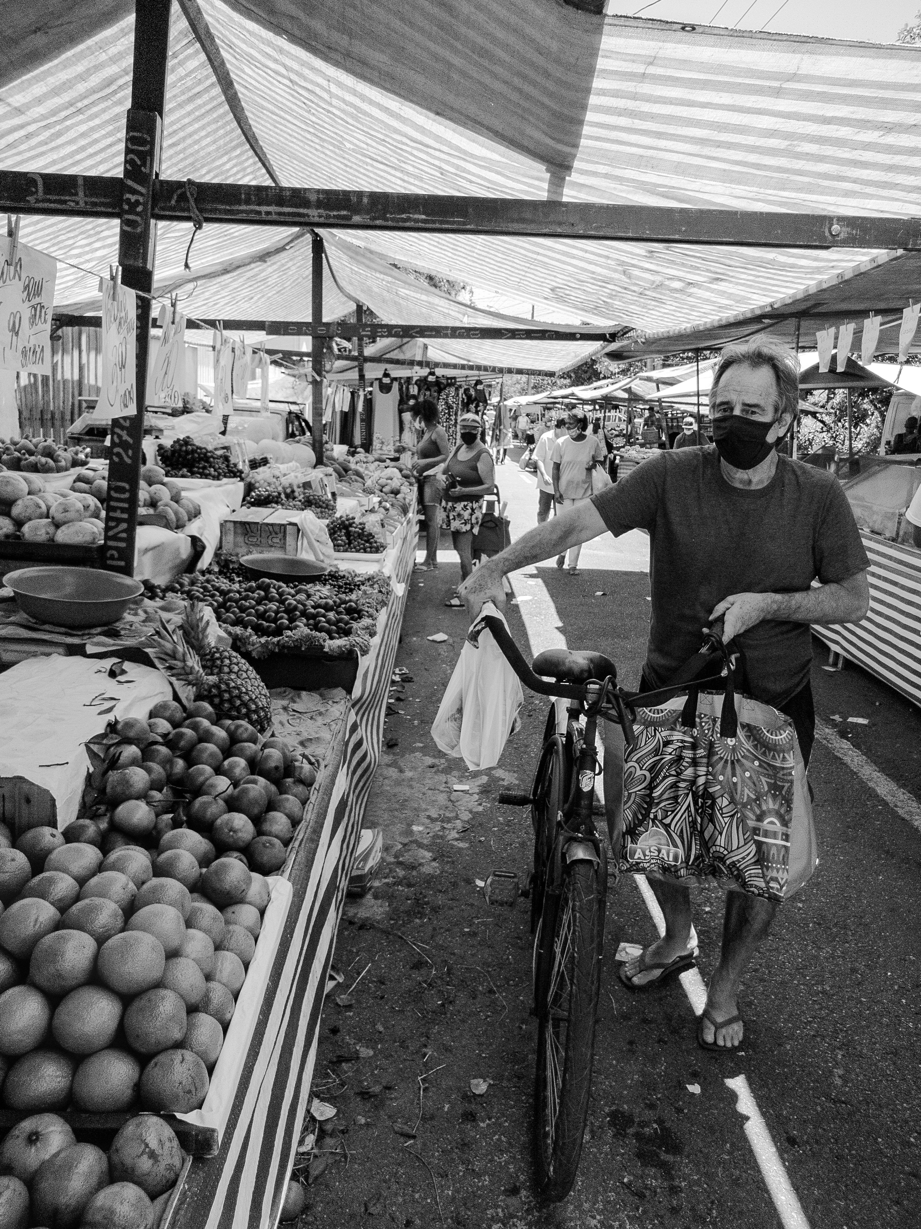 Man with Bike on a Food Market in Black and White · Free Stock Photo