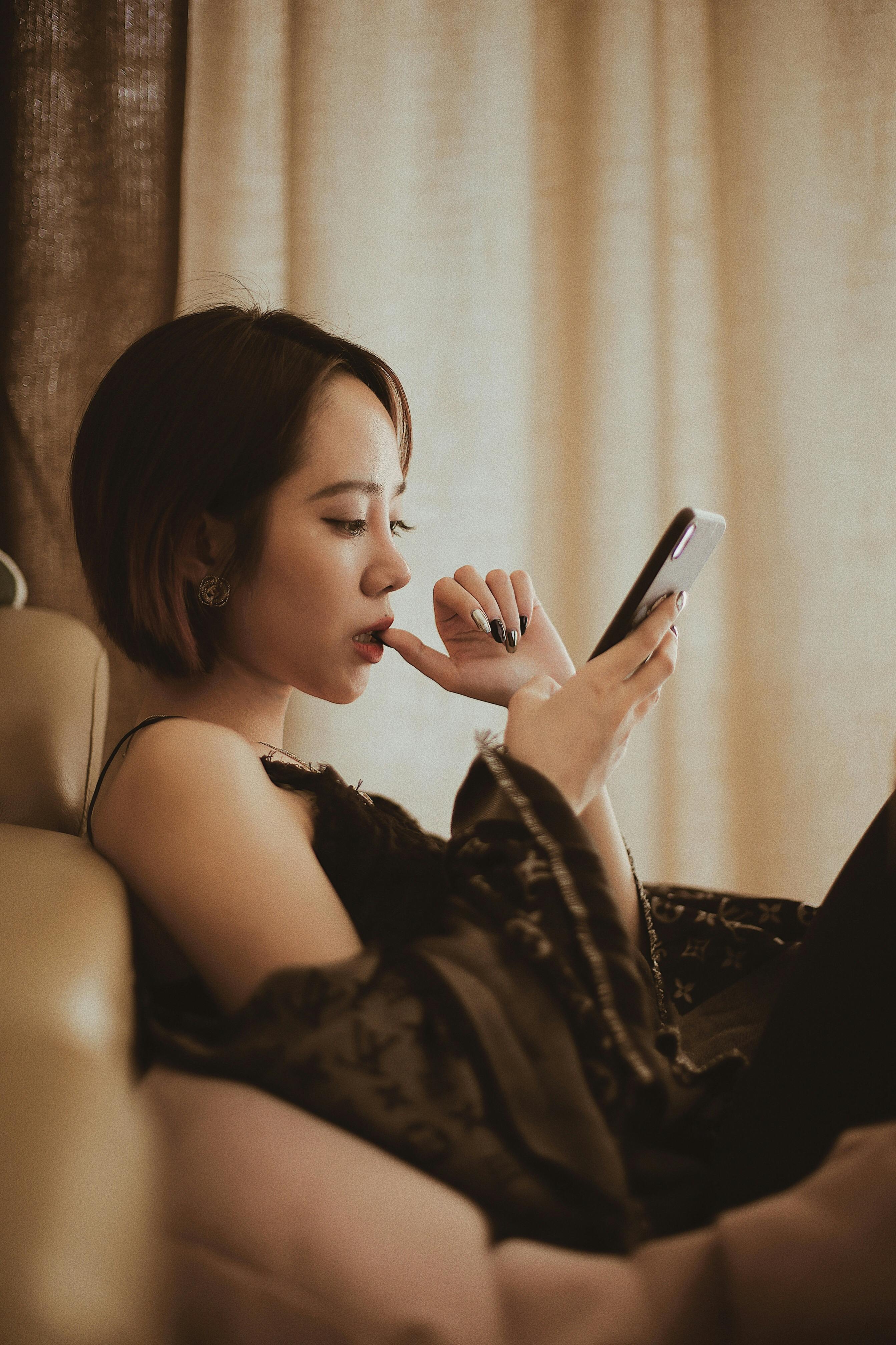 photo of woman using smartphone