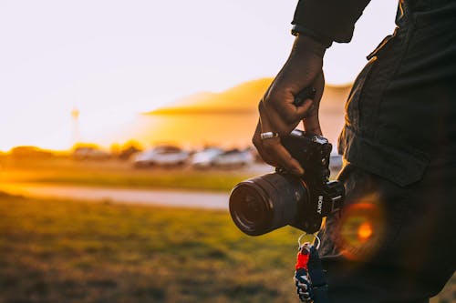 Person Holding Black Camera