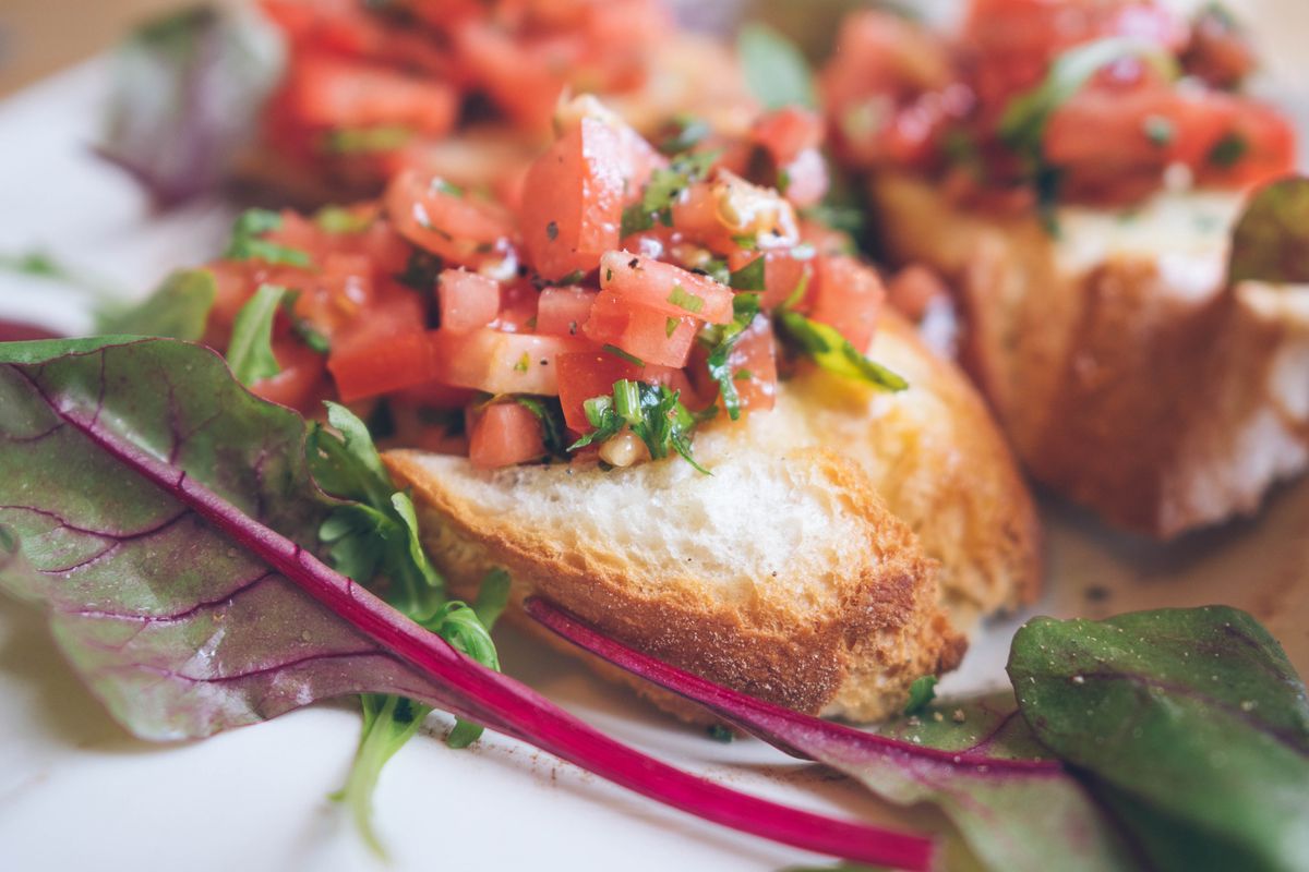 Fresh bruschetta topped with tomatoes and herbs