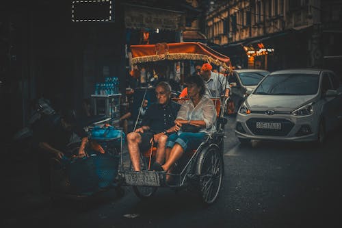 Photo of a Man and Woman Riding Carriage