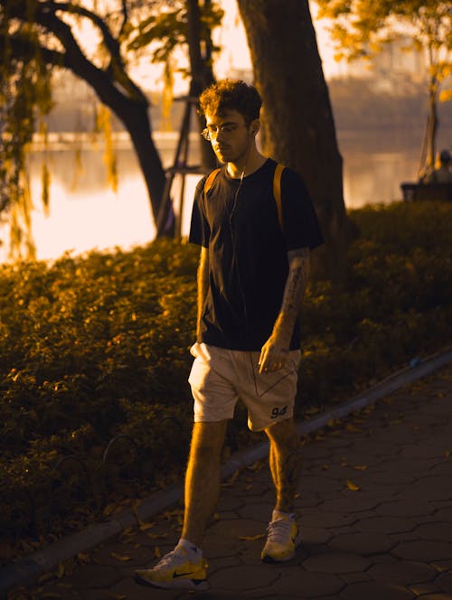 Free Photo of Man Walking on Pavement Stock Photo