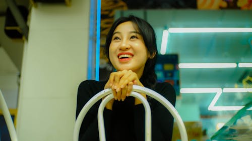 A woman smiling while sitting on a chair