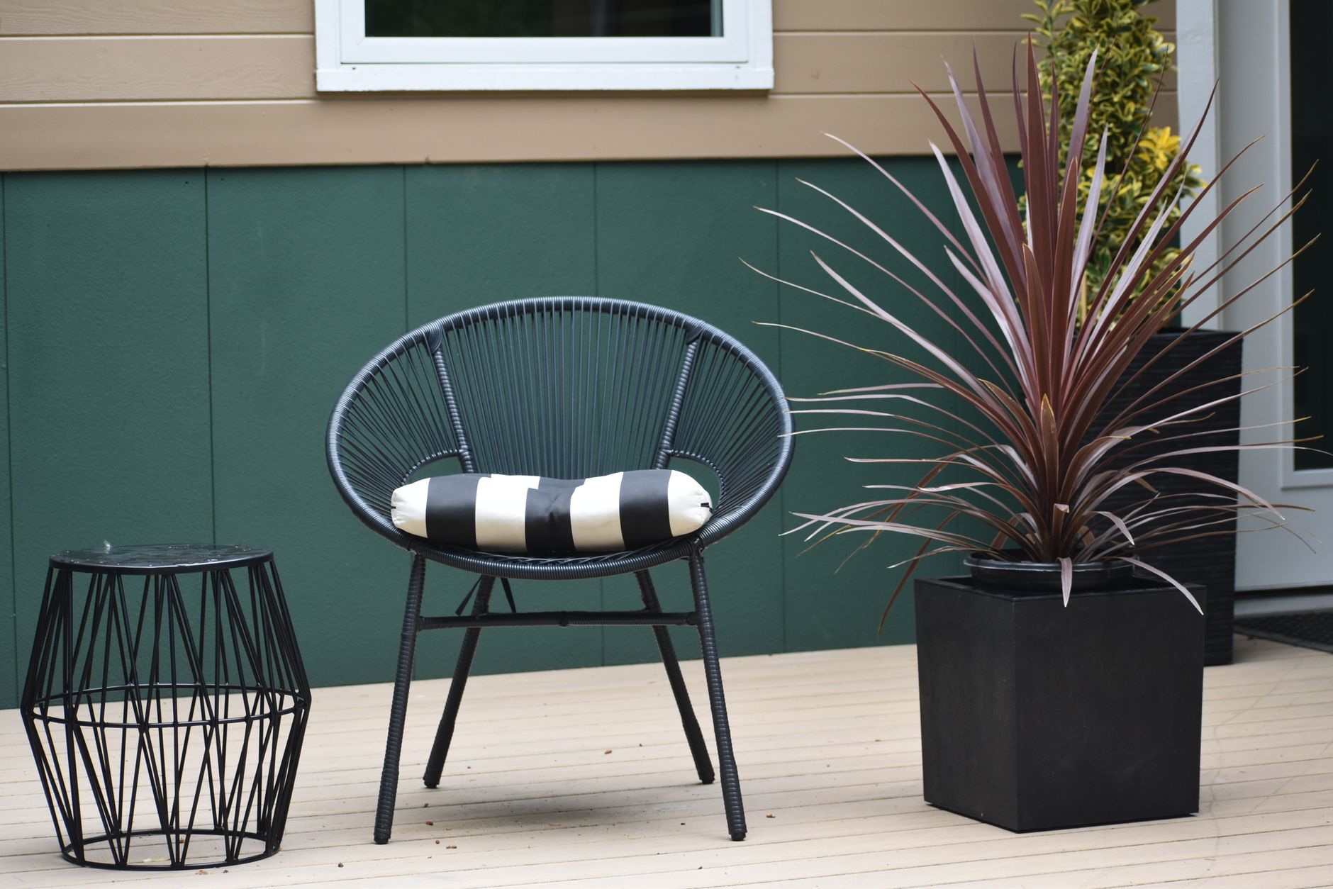 modern patio organization 2026 Modern outdoor patio scene with a distinctive chair, side table, and potted plant.