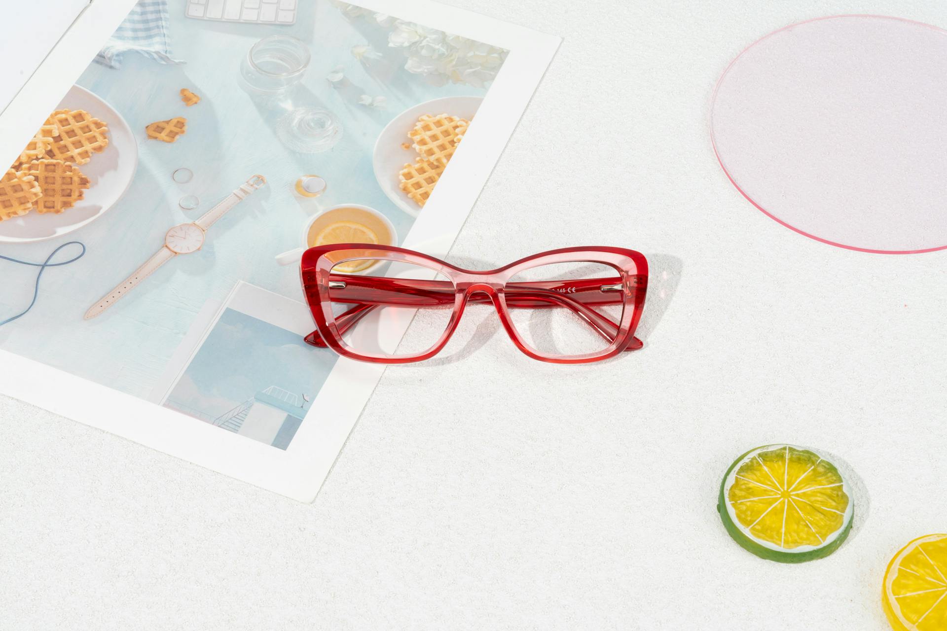 Summer Vibes: Stylish Red Prescription Glasses with Lemons and Limes on White Background