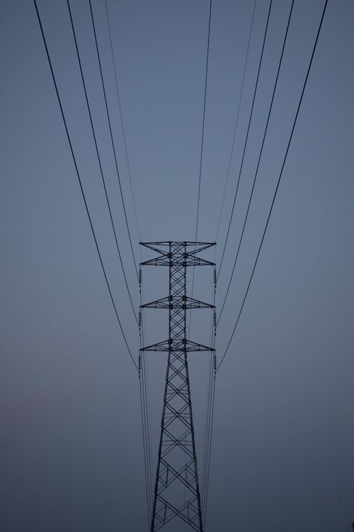 Free Silhouette of a high-voltage transmission tower against a twilight sky in Santiago de Querétaro, Mexico. Stock Photo