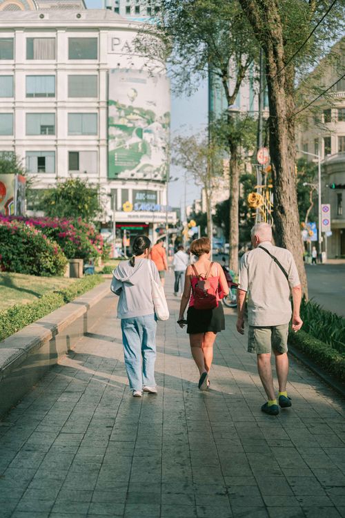Free A lively urban scene capturing people walking on a sunny day in Ho Chi Minh City, Vietnam. Stock Photo