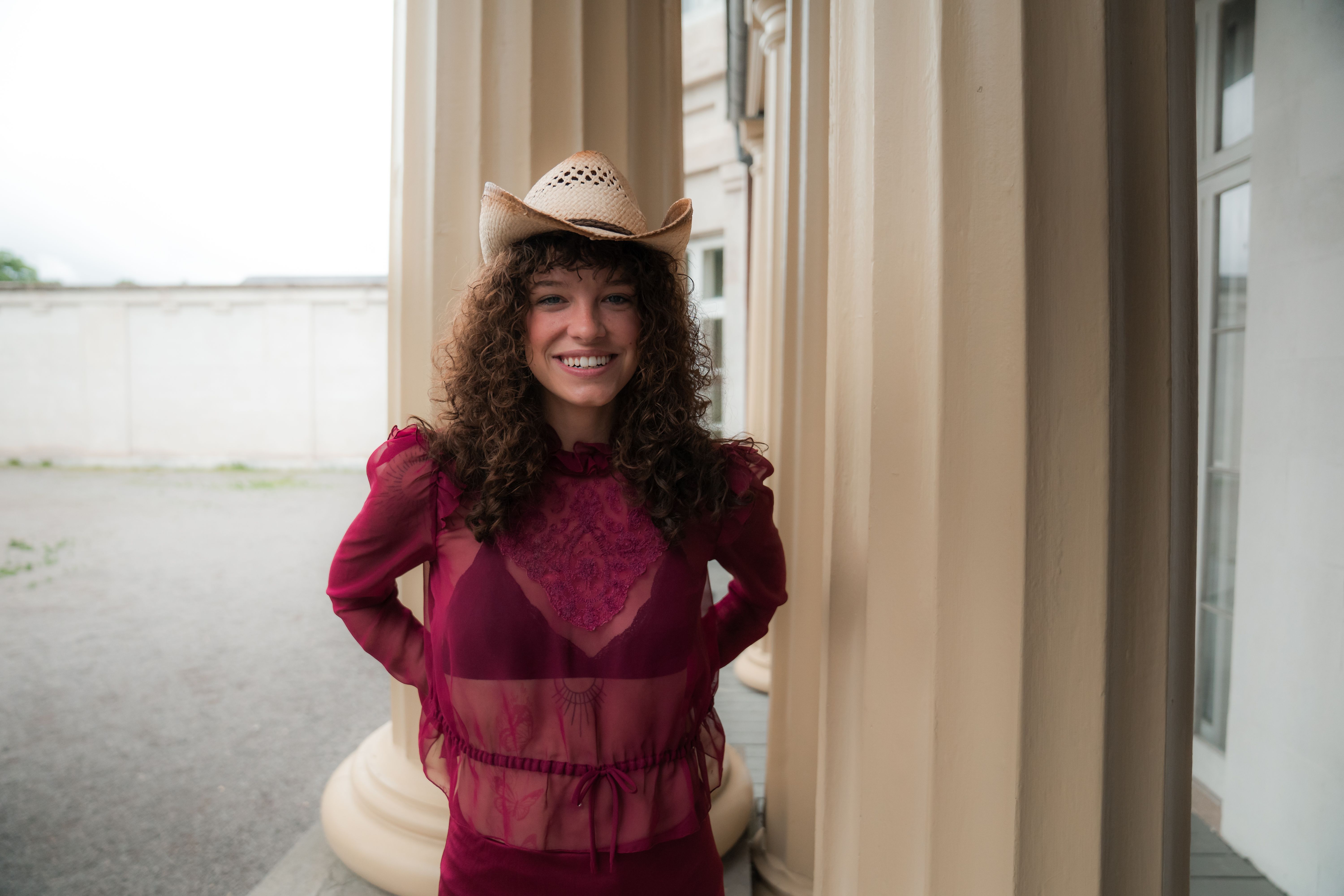A woman in a red dress and hat posing for a photo · Free Stock Photo