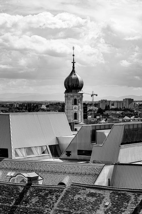 A black and white photo of a church and a roof