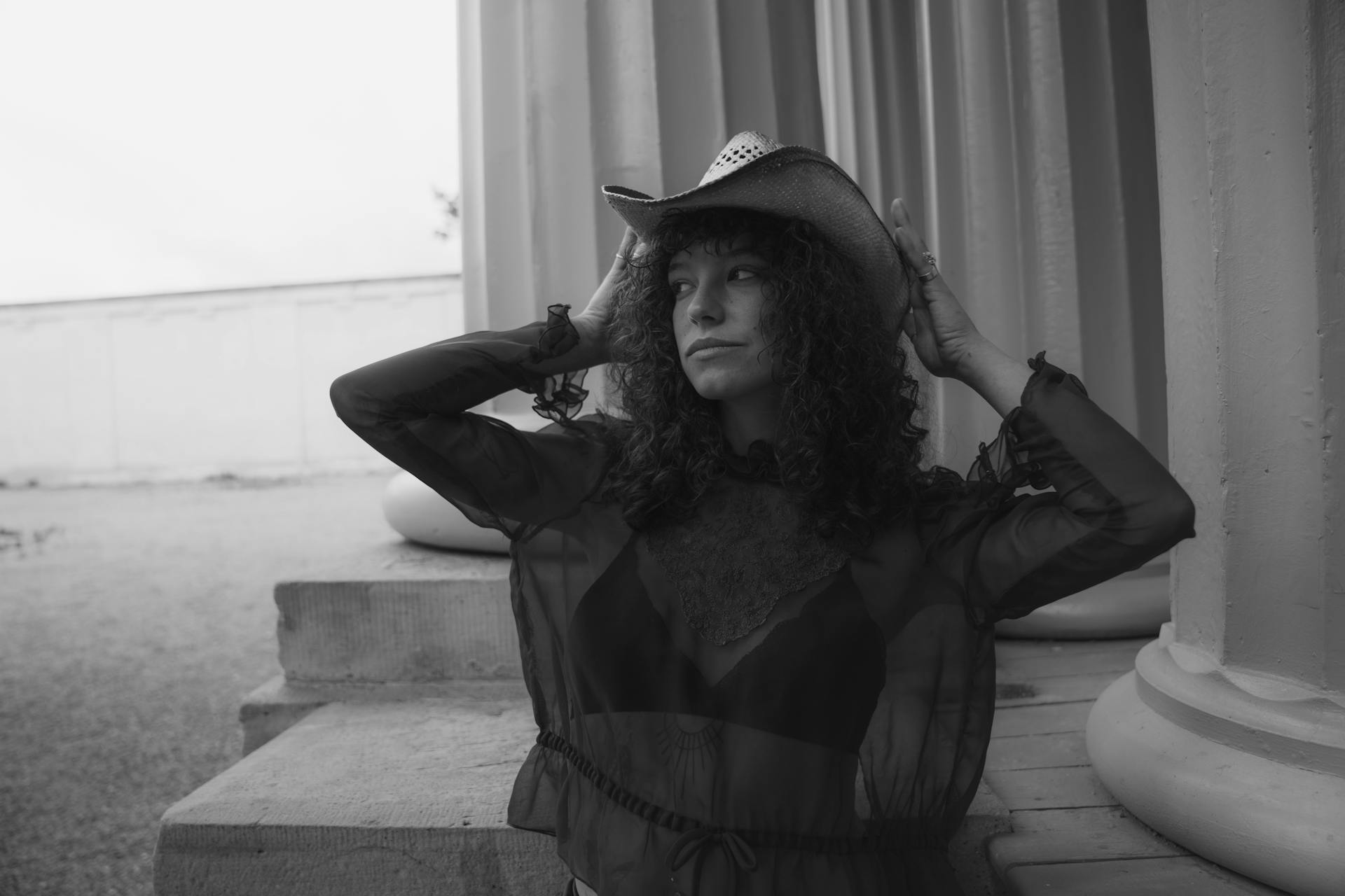 A woman in a cowboy hat and a black and white photo