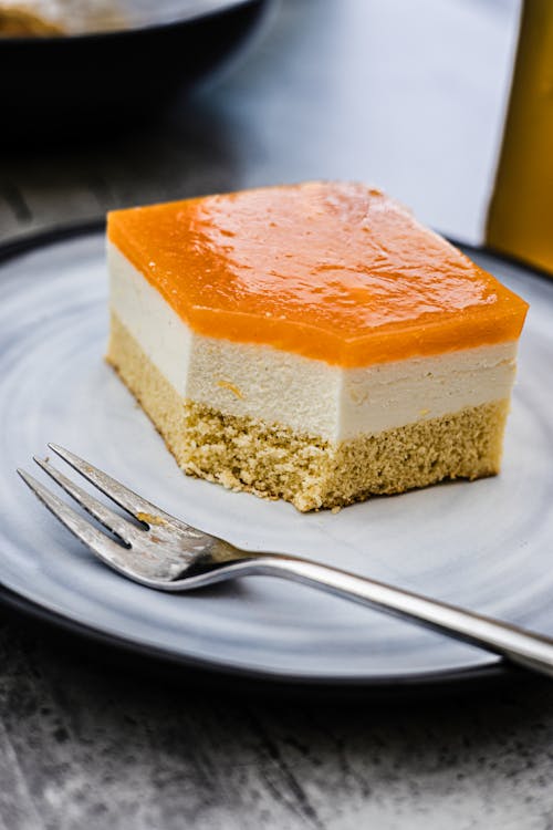 A slice of cake with orange filling on a plate