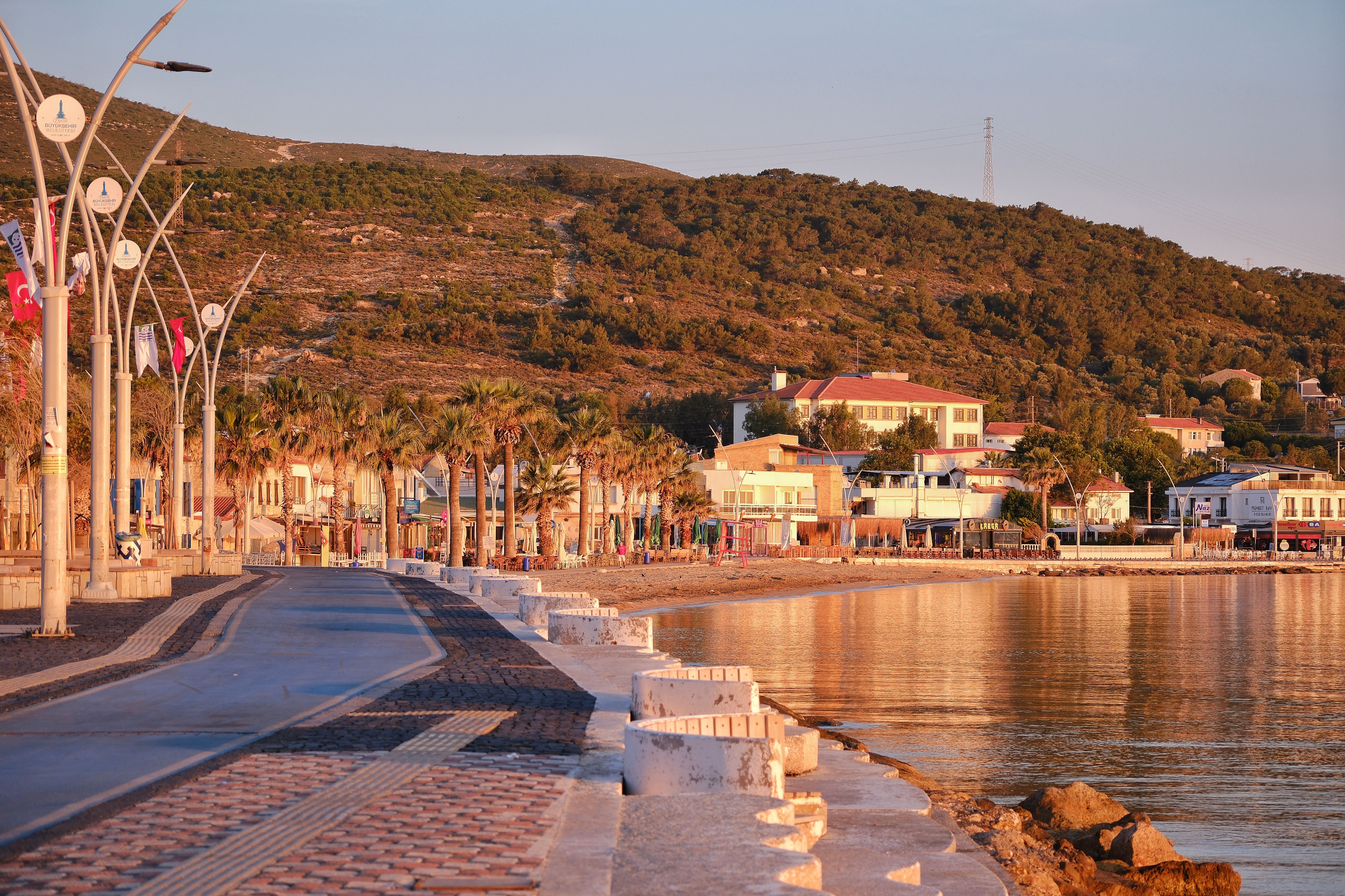 Discover the tranquil seaside promenade of Foça, İzmir, Türkiye at sunset.