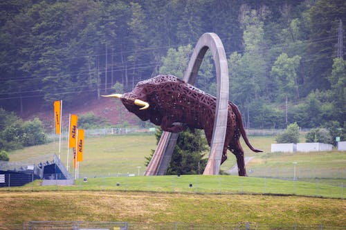 A large bull statue is in the middle of a field