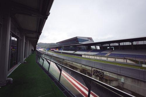 Free Empty Red Bull Ring racetrack in Spielberg, Austria with grandstands on a cloudy day. Stock Photo