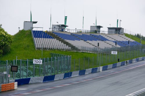A track with a fence and seats on it
