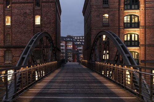 Free Evening view of Kibbelsteg Bridge connecting historic brick buildings in Hamburg. Stock Photo