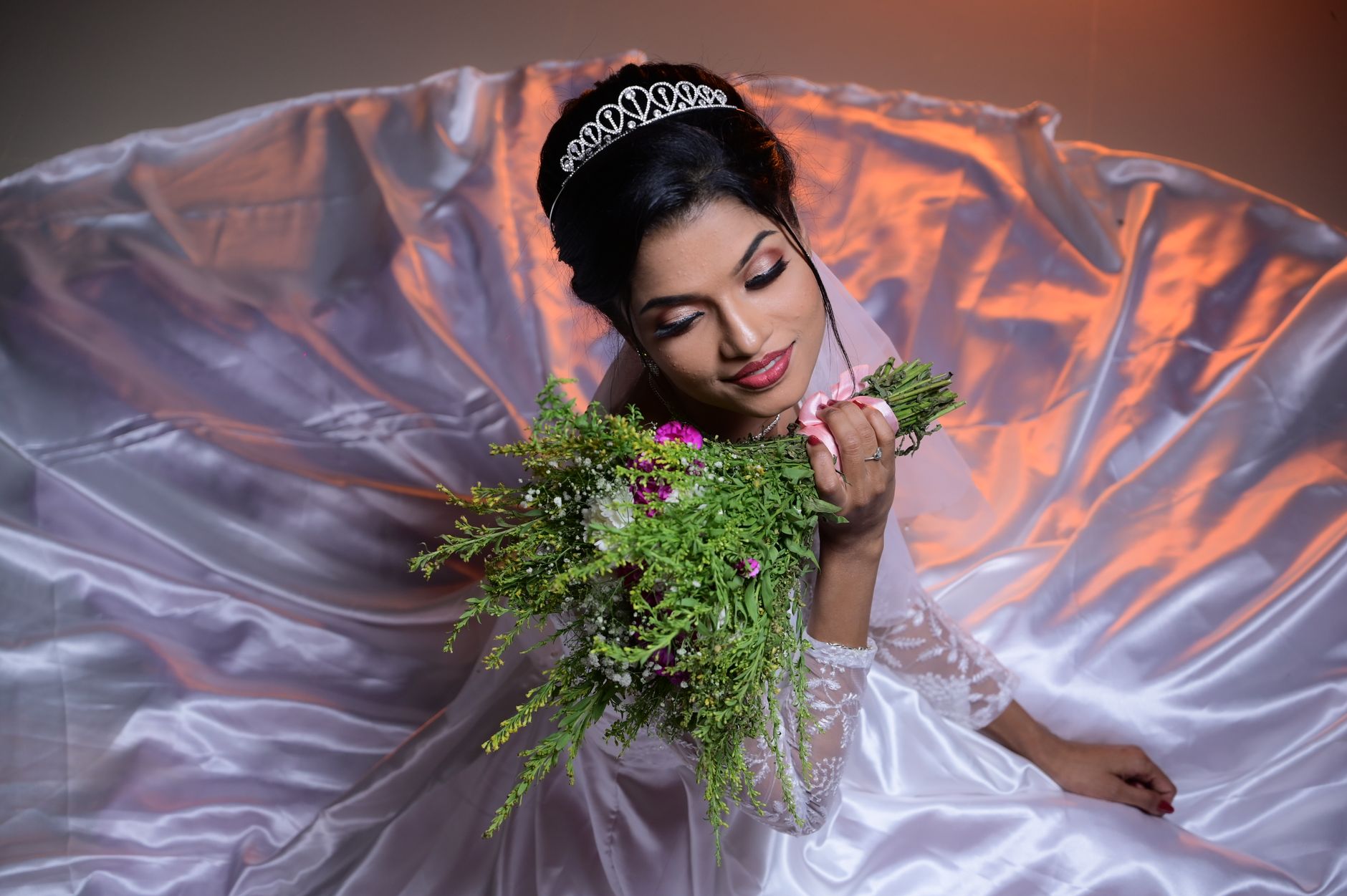 Portrait of a bride with a bouquet, showcasing elegance and grace in a New York indoor setting.