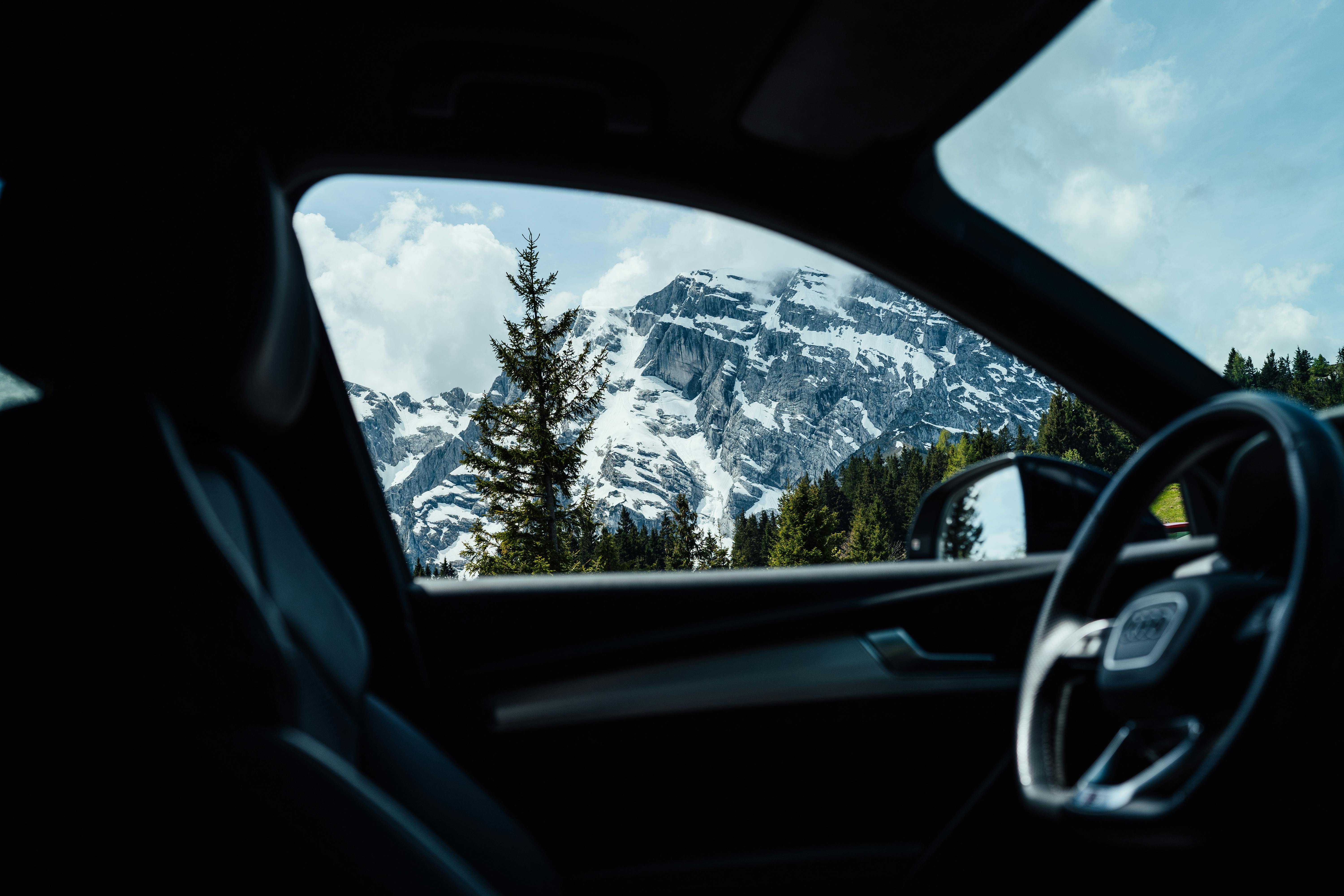 a car with a view of mountains and snow