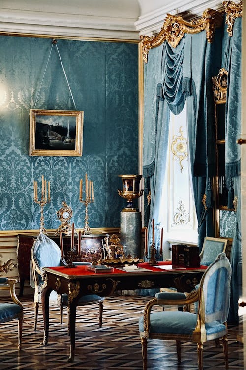 A room with blue walls and gold trim