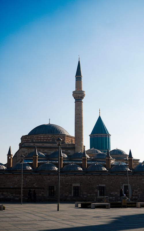 A mosque with two minarets and a clock tower