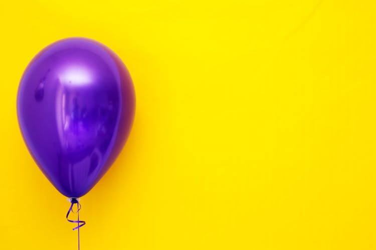 Purple Balloon Against Yellow Background