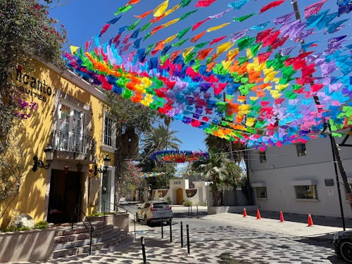 A colorful kite is hanging from a building