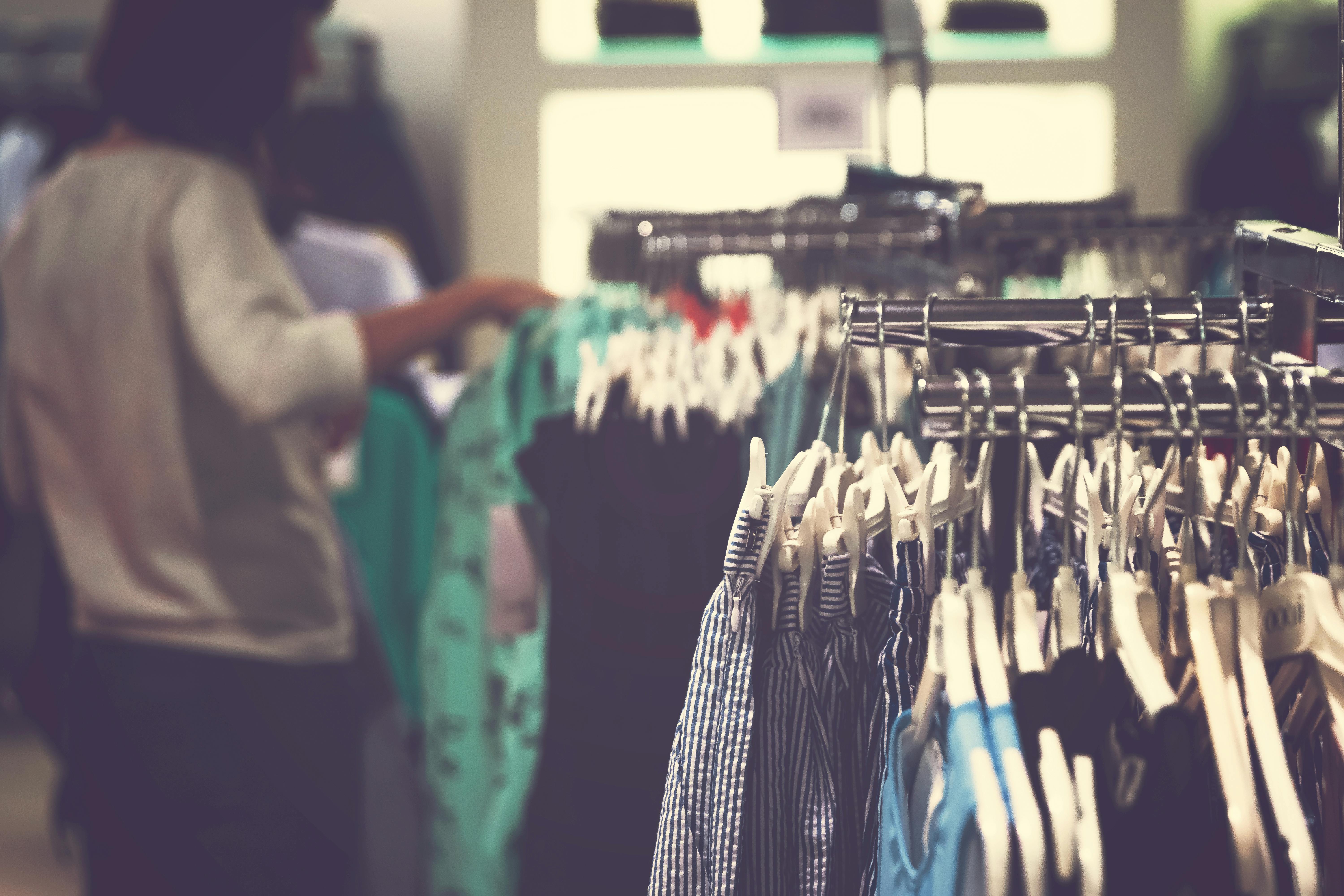 selective focus photo of clothes on clothing rack