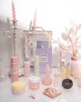 A beautifully arranged vanity with luxury skincare items and decor in pastel colors, ideal for beauty and lifestyle themes.