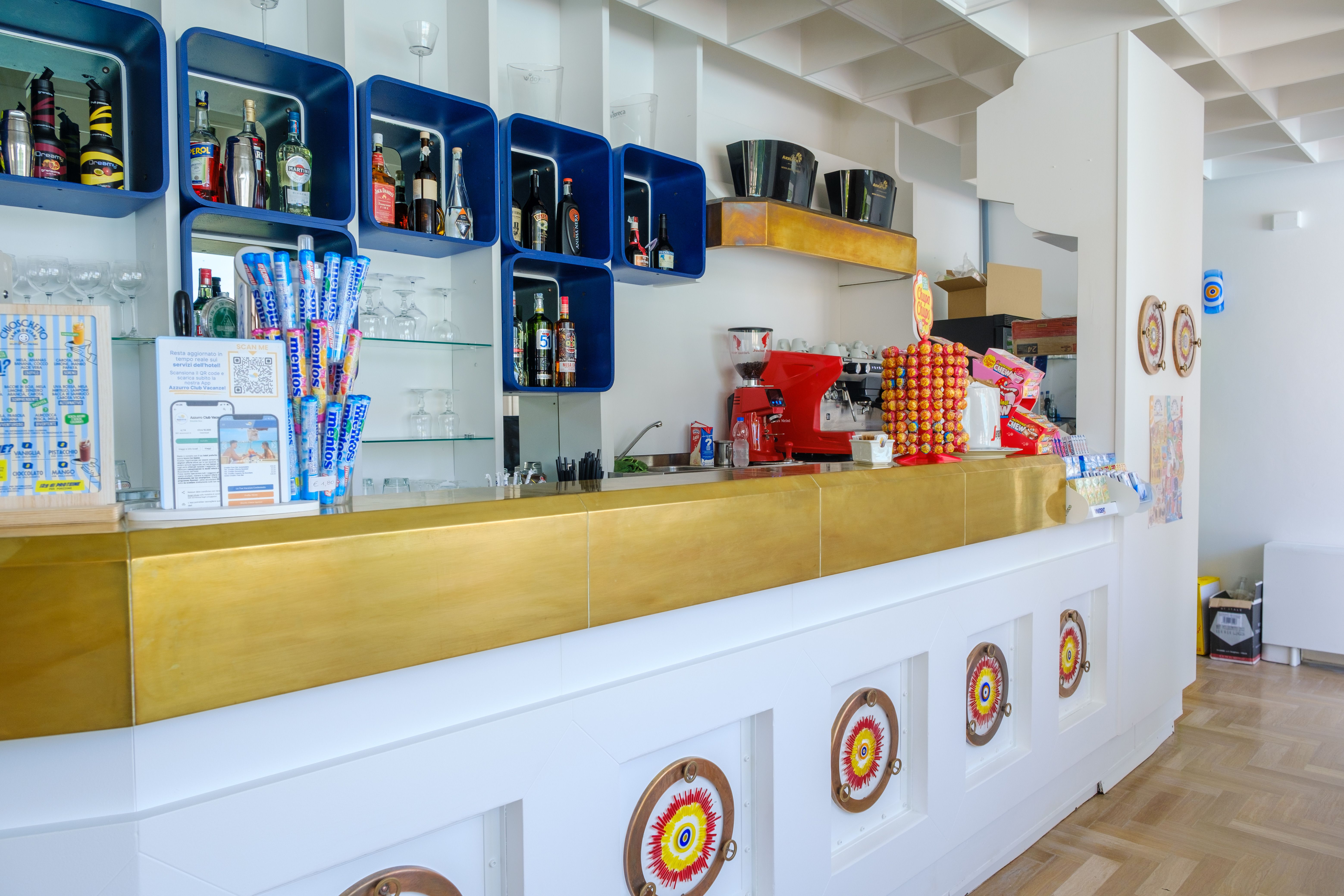 Colorful cafe counter featuring sweets and a sleek modern design.