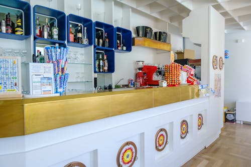 A bar with blue and yellow bottles on the counter