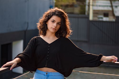 Photo of a Woman Leaning on Railings