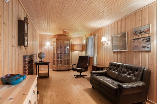 A living room with wood paneling and a couch