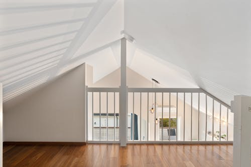 A loft with wooden floors and a skylight