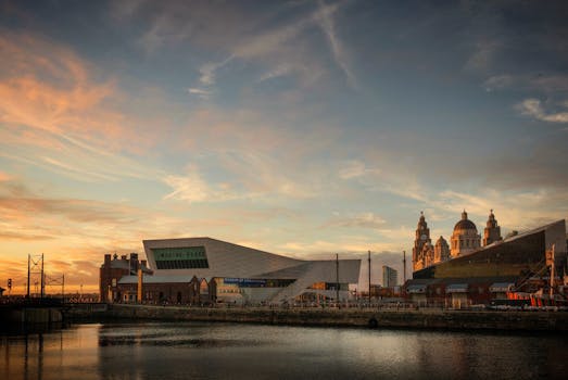 Beautiful view of Liverpool's iconic waterfront with buildings and the Museum of Liverpool at sunset. by Charles Pragnell