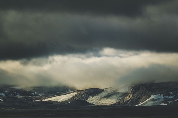 Mountains under a dark overcast sky. Photo by Francesco Ungaro on Pexels