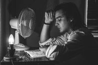 Monochrome  Photo of Man Leaning on Table