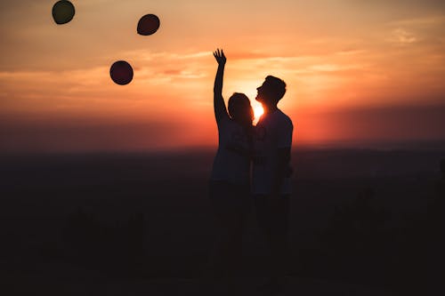 Free Silhouette Photo of Couple Standing Outdoors Stock Photo