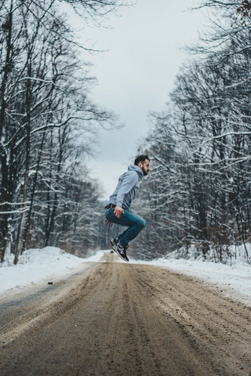 Free Photo of Man Jumping on Dirt Road Stock Photo